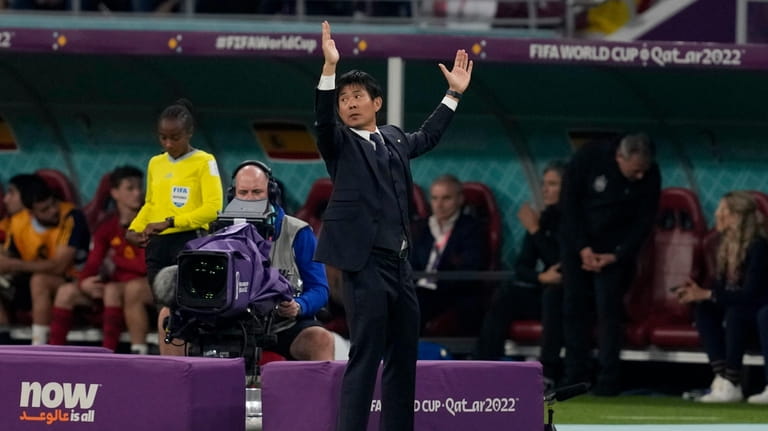 Japan's head coach Hajime Moriyasu reacts during the World Cup...