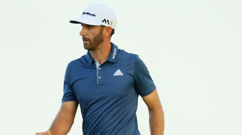 Dustin Johnson of the United States reacts to his putt...