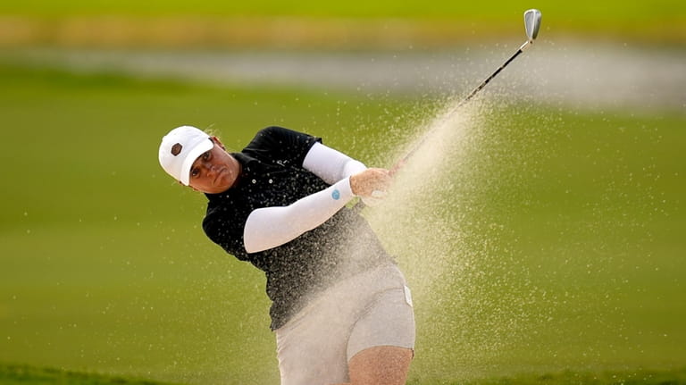 Lauren Coughlin hits from the fifth fairway bunker during the...