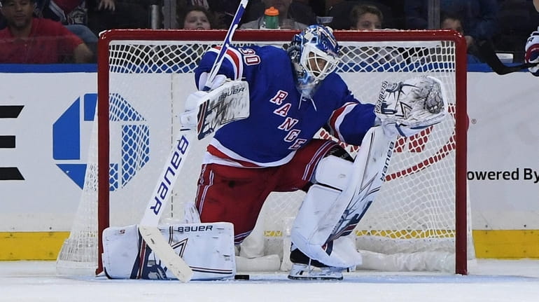 New York Rangers goalie Henrik Lundqvist reacts after giving up...