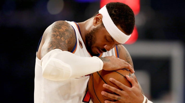 Carmelo Anthony #7 of the New York Knicks hugs the...