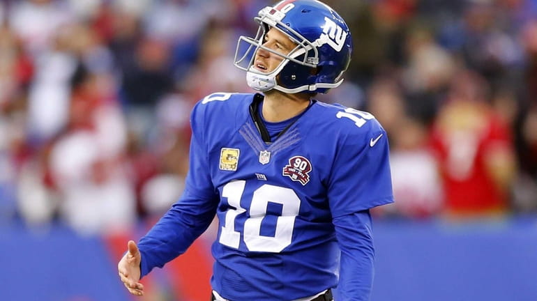 Eli Manning of the New York Giants reacts after throwing...