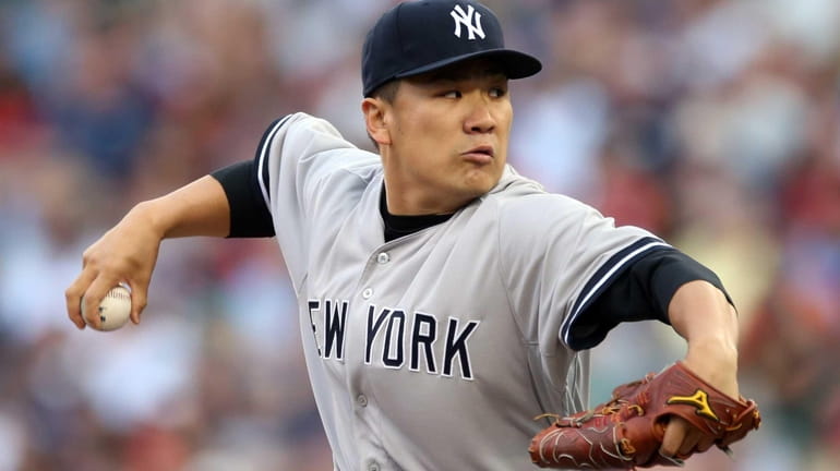 Yankees pitcher Masahiro Tanaka delivers a pitch during the first...