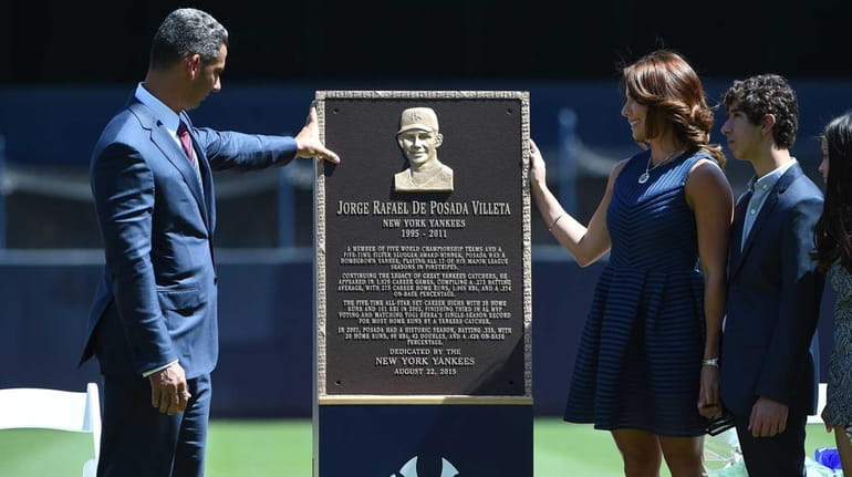 Former New York Yankees catcher Jorge Posada looks at his...