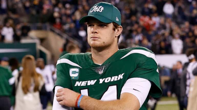 Sam Darnold of the Jets walks off the field after...
