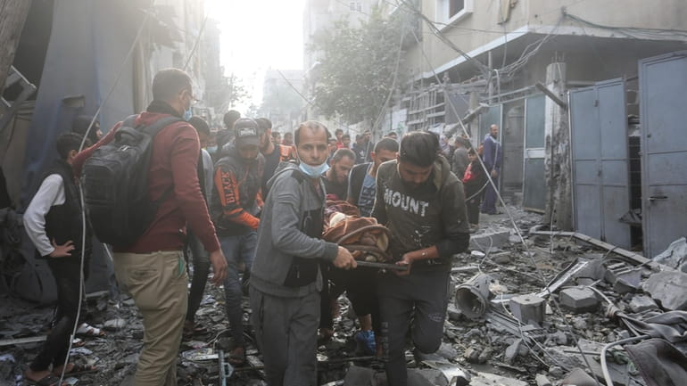 Palestinians evacuate wounded in Israeli bombardment Rafah, Gaza Strip, Friday,...