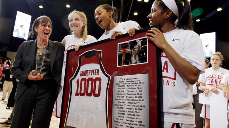 Stanford coach Tara VanDerveer, left, celebrates with her players, including...