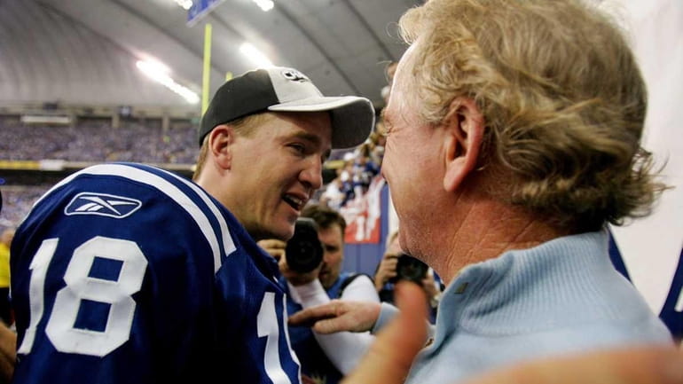 Quarterback Peyton Manning of the Indianapolis Colts is congratulated by...