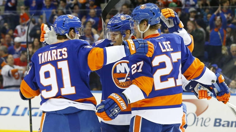 Kyle Okposo #21 of the New York Islanders celebrates his...