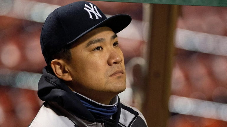 Yankees starting pitcher Masahiro Tanaka watches the game from the...