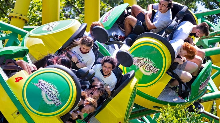 People hang on as they ride Turbulence at Adventureland amusement...