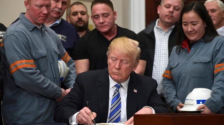 President Trump signs a proclamation on steel imports on Thursday,...