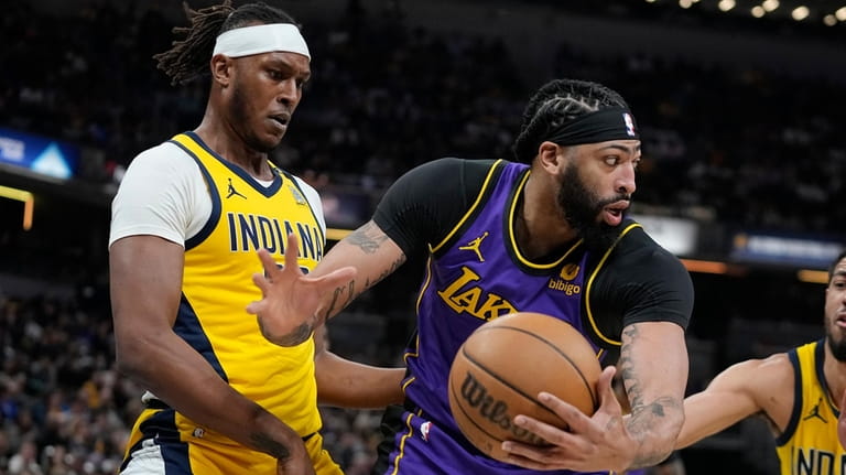 Los Angeles Lakers' Anthony Davis is defended by Indiana Pacers'...