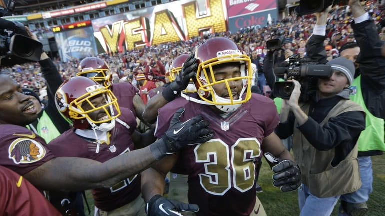 Washington Redskins fullback Darrel Young is congratulated by his teammates...