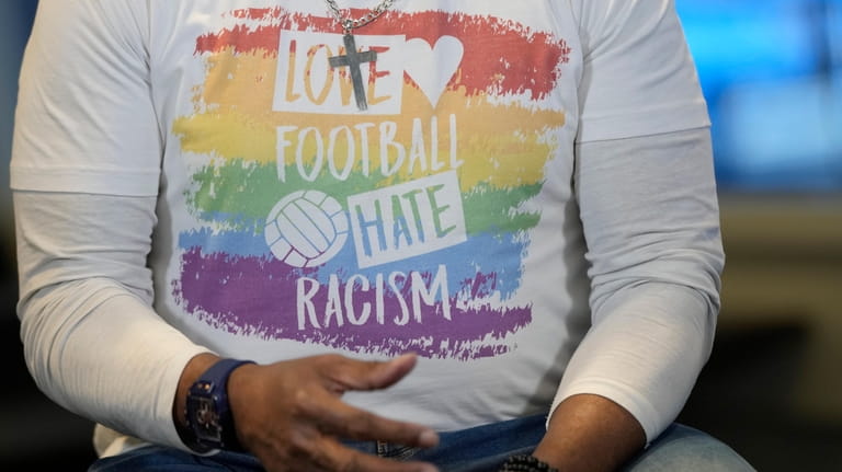 A close-up of the anti-racism message on the t-shirt of...
