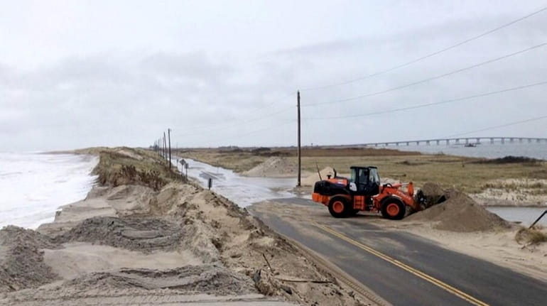 Sand is removed from Dune Road near the Shinnecock Commercial...