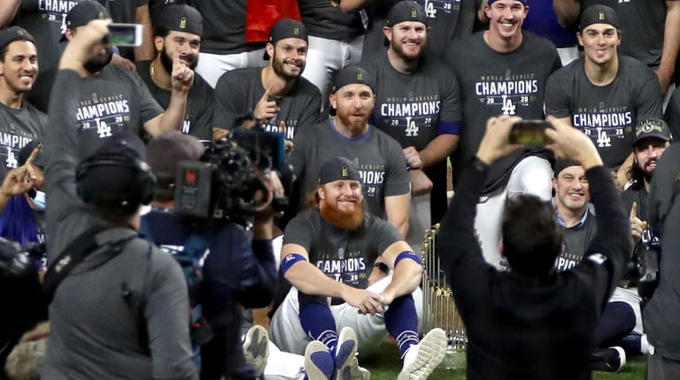 Justin Turner #10 and the Los Angeles Dodgers pose for...