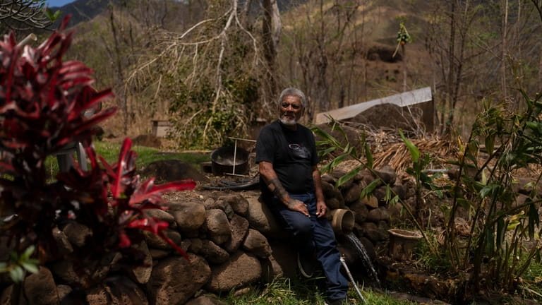 Keʻeaumoku Kapu poses for photos on his taro farm near...