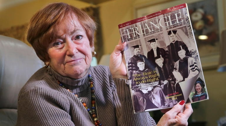 Mary Ann Fox of Ridge with a 2004 edition of Triangle, the Springfield College...