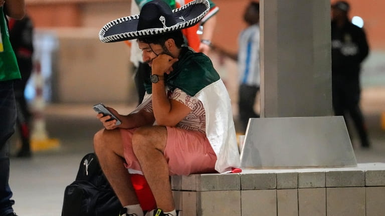A Mexico supporter sits outside Lusail Stadium following following Argentina's...