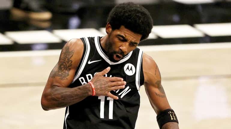 Kyrie Irving of the Brooklyn Nets celebrates after he was...