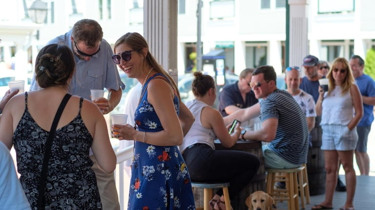 Patrons sip craft beer and mingle on the front patio...