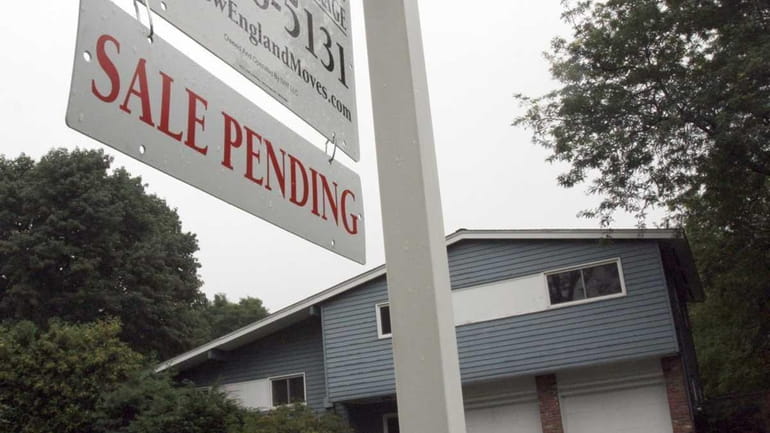 A sign announces a pending residential home sale this past...