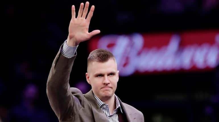 Knicks' Kristaps Porzingis waves to fans before a game against the...