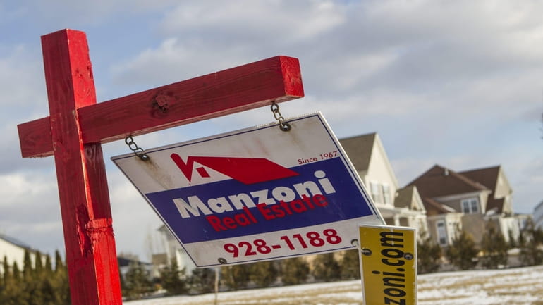 Long Island home prices were nearly flat last month, despite...