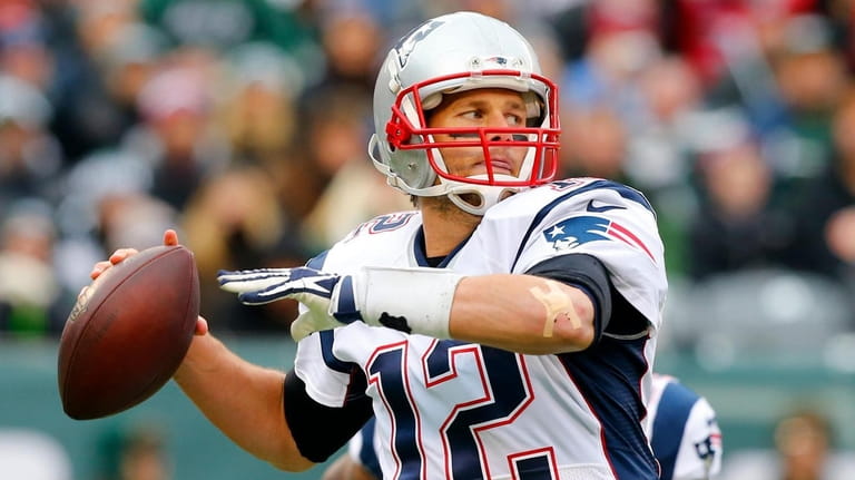 Tom Brady #12 of the New England Patriots throws a...