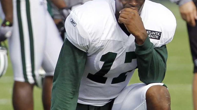 New York Jets wide receiver Plaxico Burress looks on during...