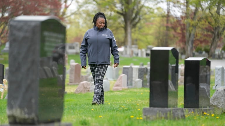 Debra Long walks near the tombstone of her son, Randy...