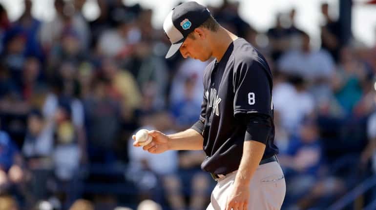 New York Yankees pitcher James Kaprielian pauses on the mound...