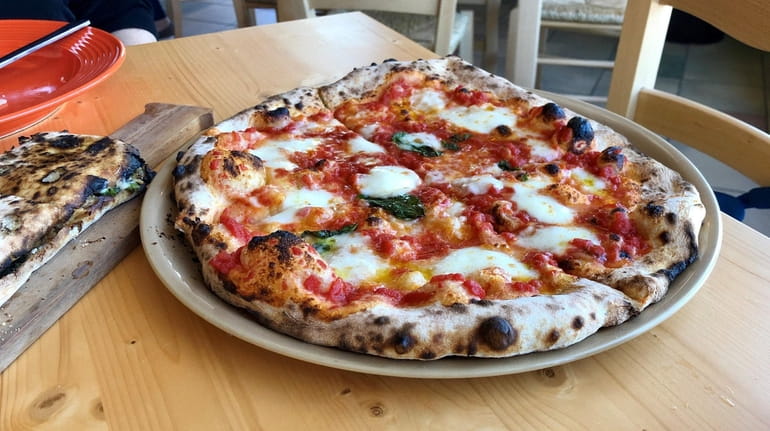 A Margherita pizza is served at Naples Street Food in...