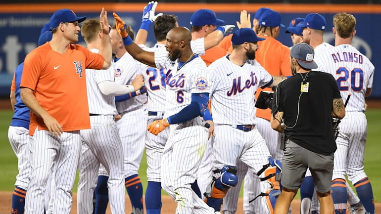 The Mets' Starling Marte celebrates with teammates after his walk-off...