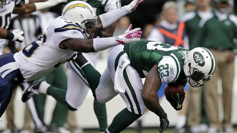 San Diego Chargers' Donald Butler, left, tackles New York Jets'...