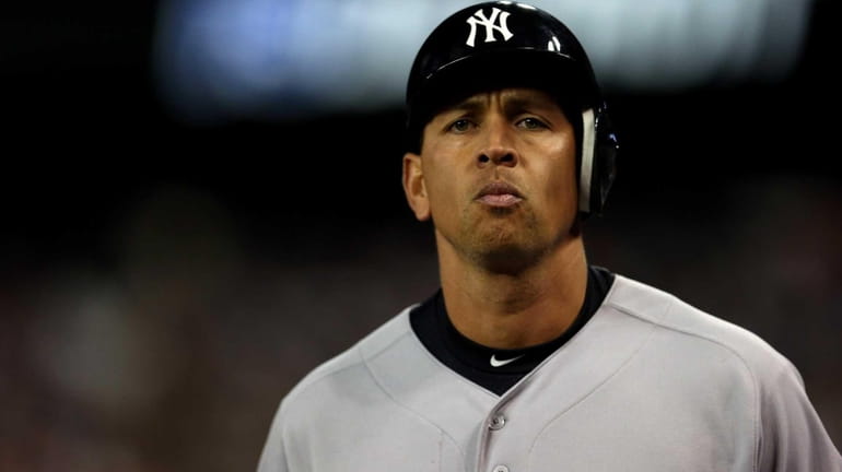 Alex Rodriguez of the Yankees walks off the field after...