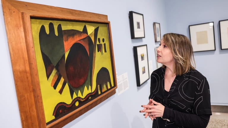 Heckscher Museum executive director, Heather Arnet, with Dove's painting, "Indian...