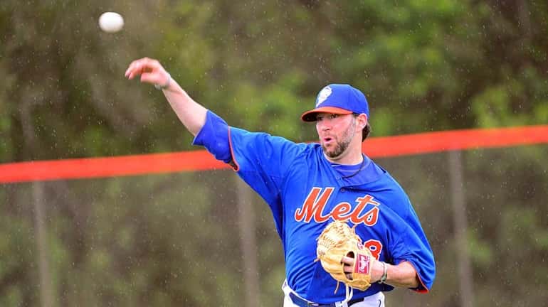 Mets pitcher Shaun Marcum plays catch during a spring training...