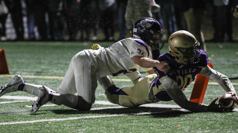 Kyle Messina of Sayville dives into the end zone for...