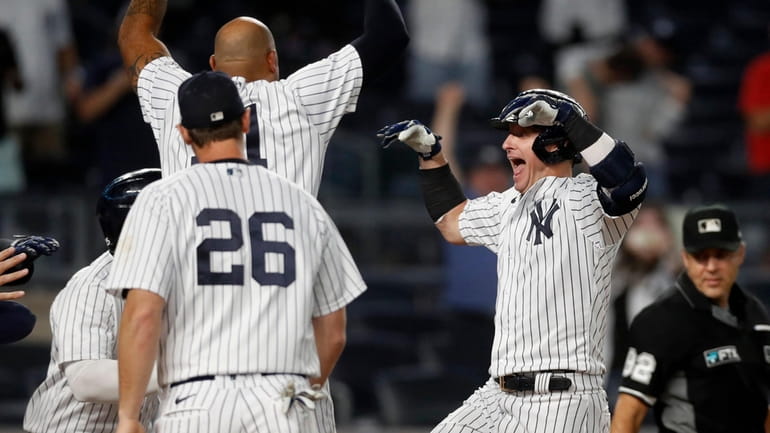 Josh Donaldson of the Yankees celebrates his 10th-inning walk-off grand...
