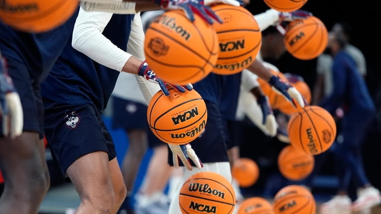 UConn players warm up during practice for their Sweet Sixteen...