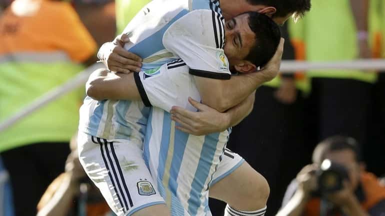 Argentina's Angel di Maria, right, and Lionel Messi celebrate after...