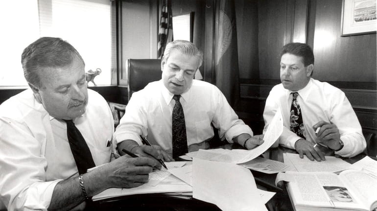 Then-Nassau County Executive Thomas Gulotta, center, works with special assistant...