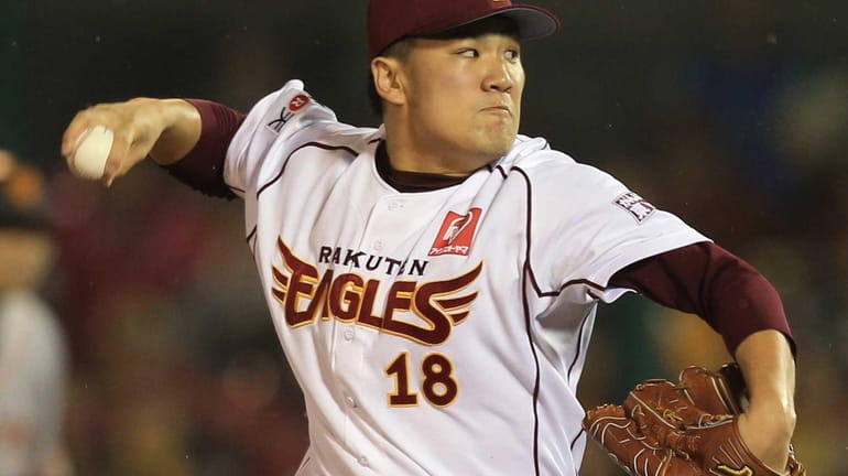 Rakuten Eagles pitcher Masahiro Tanaka hurls the ball against the...