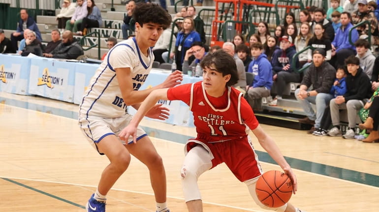 Southold's Jacob Steinfeld takes the ball down the court in...