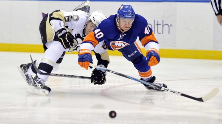 Ben Lovejoy of the Penguins and Michael Grabner of the...