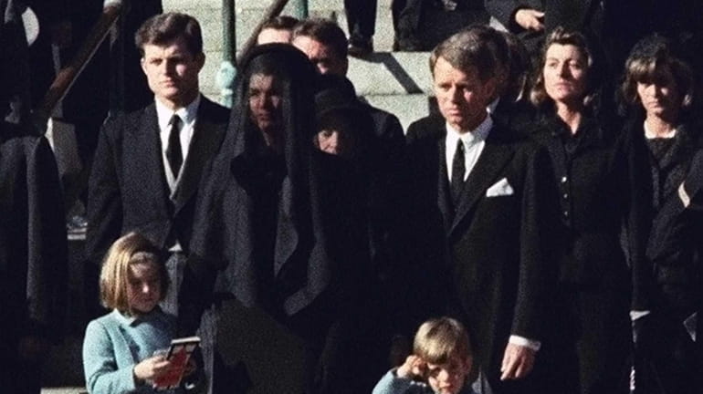 Three-year-old John F. Kennedy Jr. salutes his father's casket in...