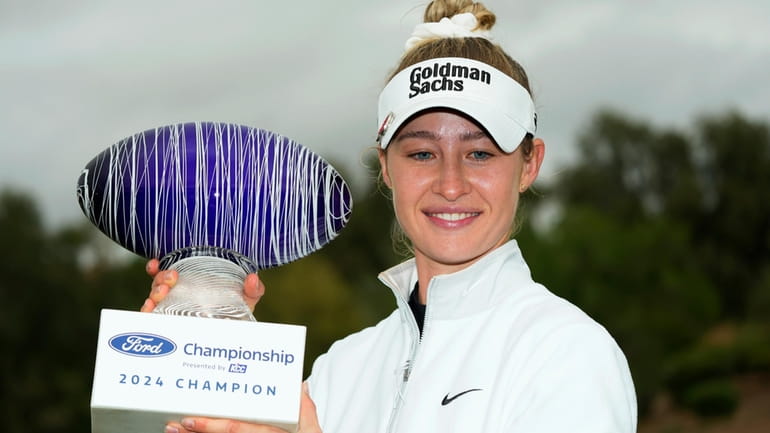 Nelly Korda smiles as she poses for photographs with the...