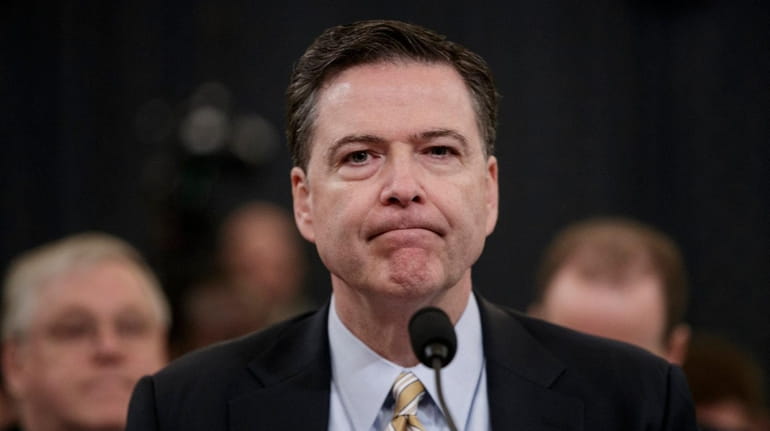 FBI Director James Comey pauses as he testifies on Capitol...